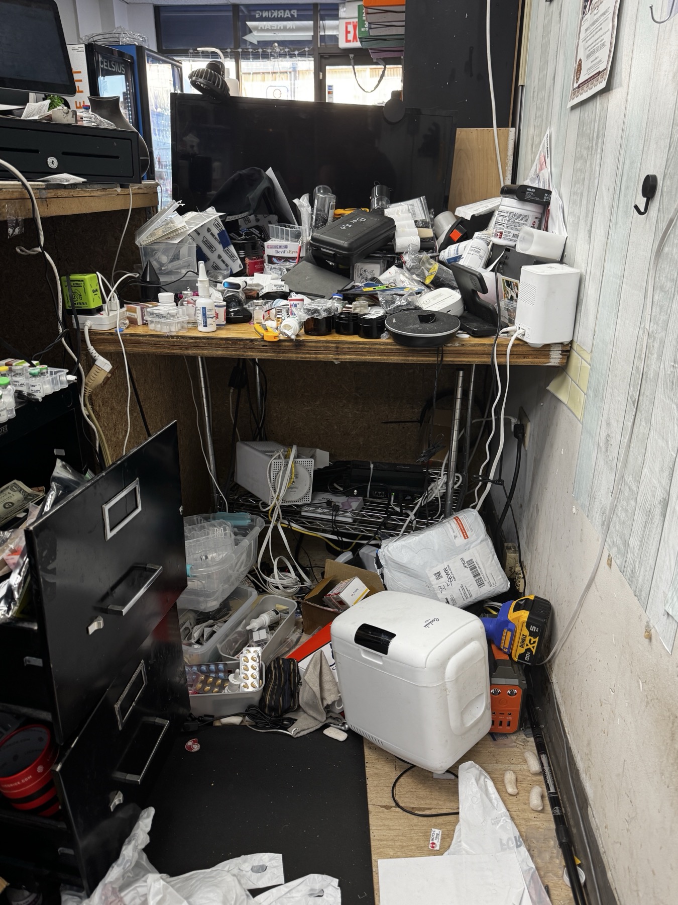 Before networking cleanup at Tommy K Supplements with crowded counter, loose cables, and equipment spread across the workspace.